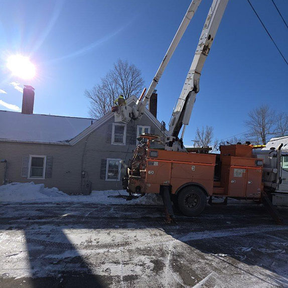 A utility truck parked in front of a residential house, showcasing its service role in the neighborhood.